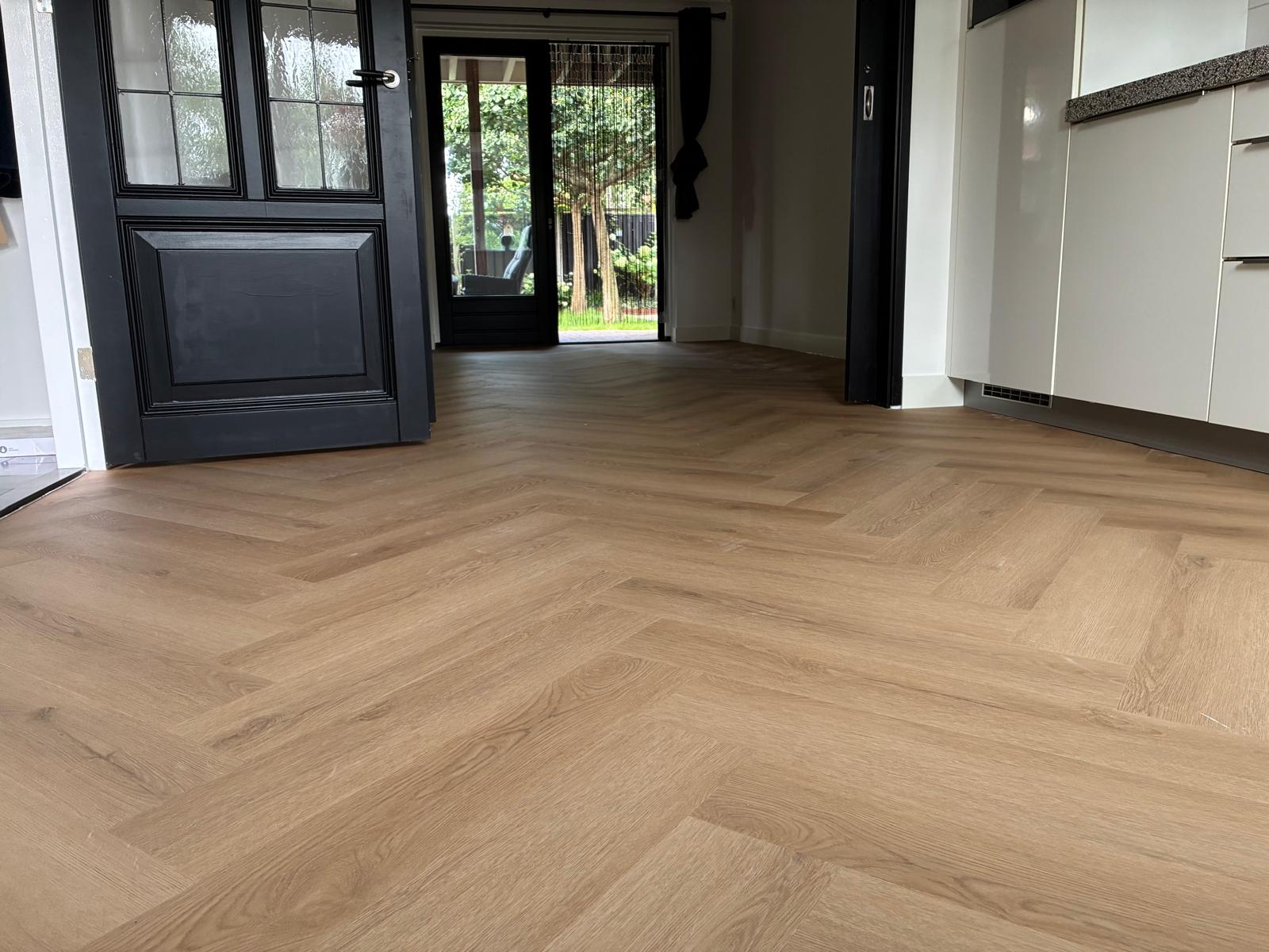 Naturel eiken visgraatvloer van woonkamer tot keuken in Rijssen